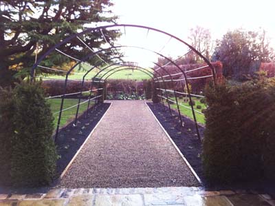 Bespoke Metal Arch over gravel path